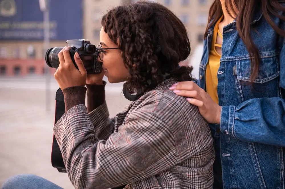 Black Women Photographers x Nikon Photography Grants walking roadside and taking shot